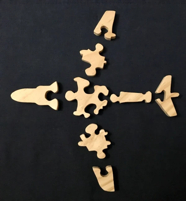 Separated pieces of a wooden puzzle of an airplane