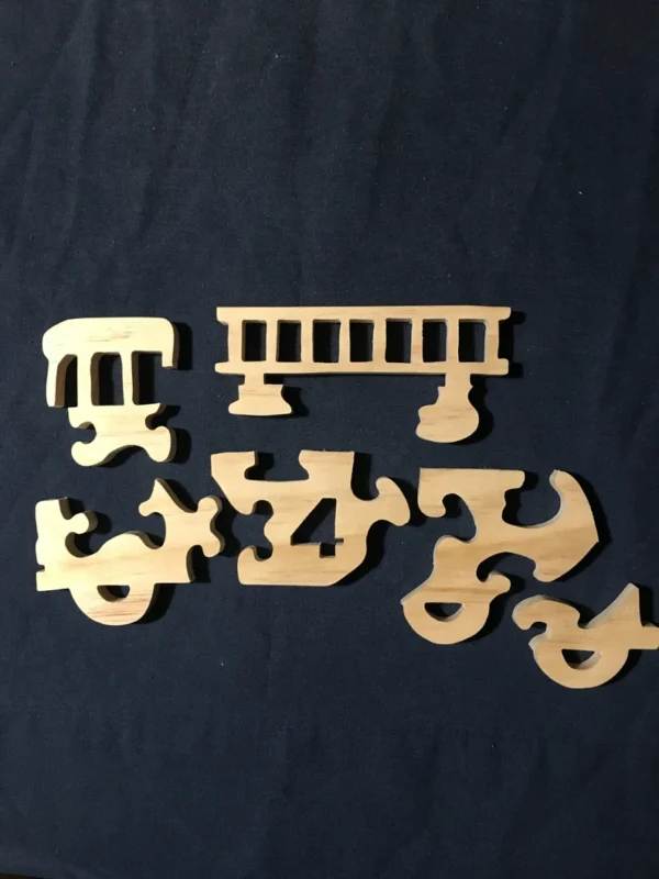 separated pieces of a wooden fire truck puzzle