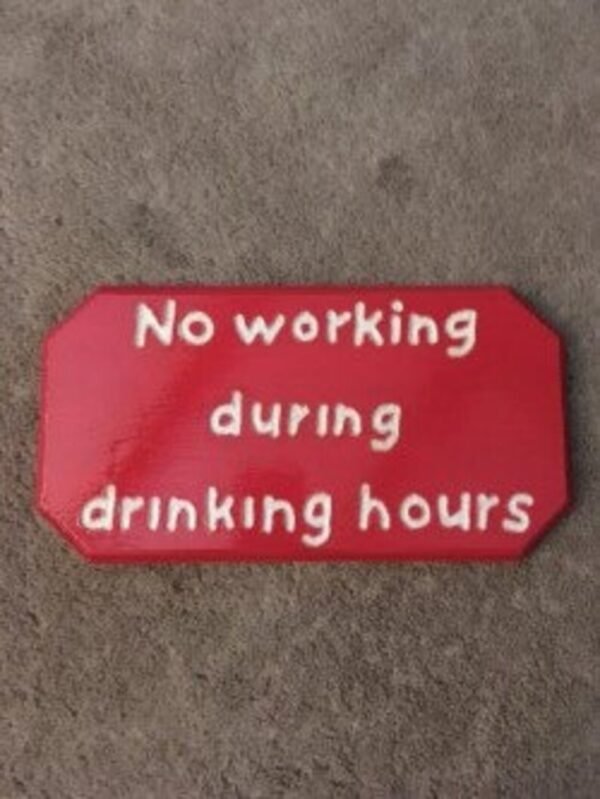 Red wooden plaque that says "no working during drinking hours"