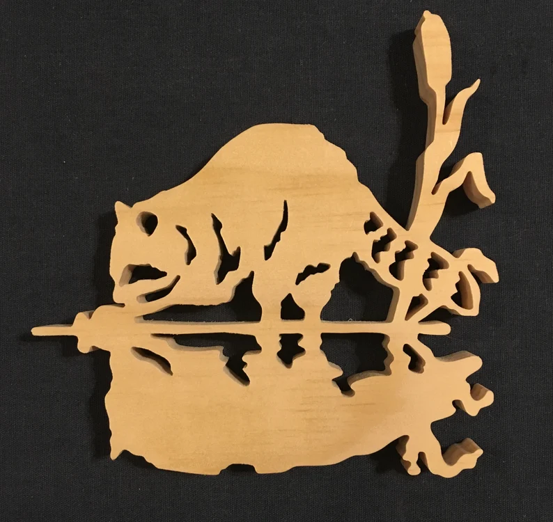 Wooden racoon with reflection in water made from a scroll saw