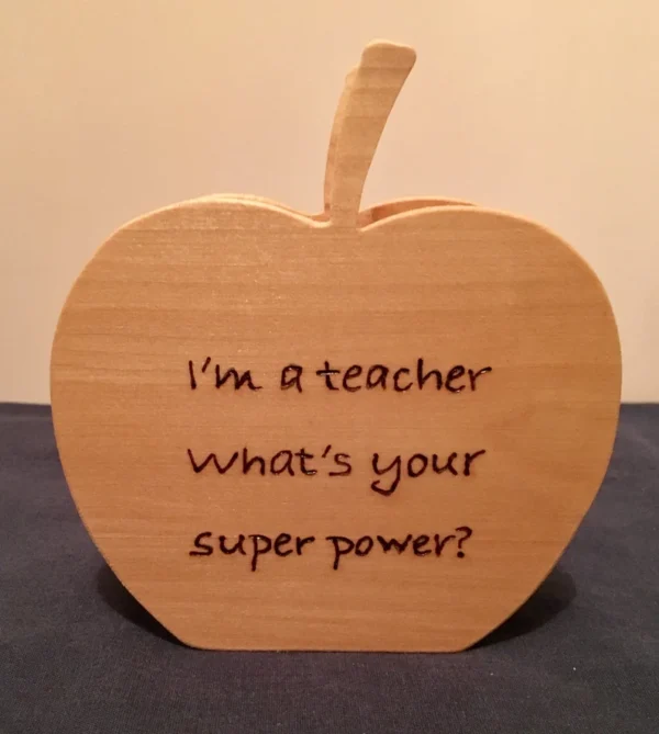 Wooden pencil holder that says "I'm a teacher, what's your super power?" on it