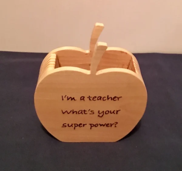 Wooden pencil holder that says "I'm a teacher, what's your super power?" on it