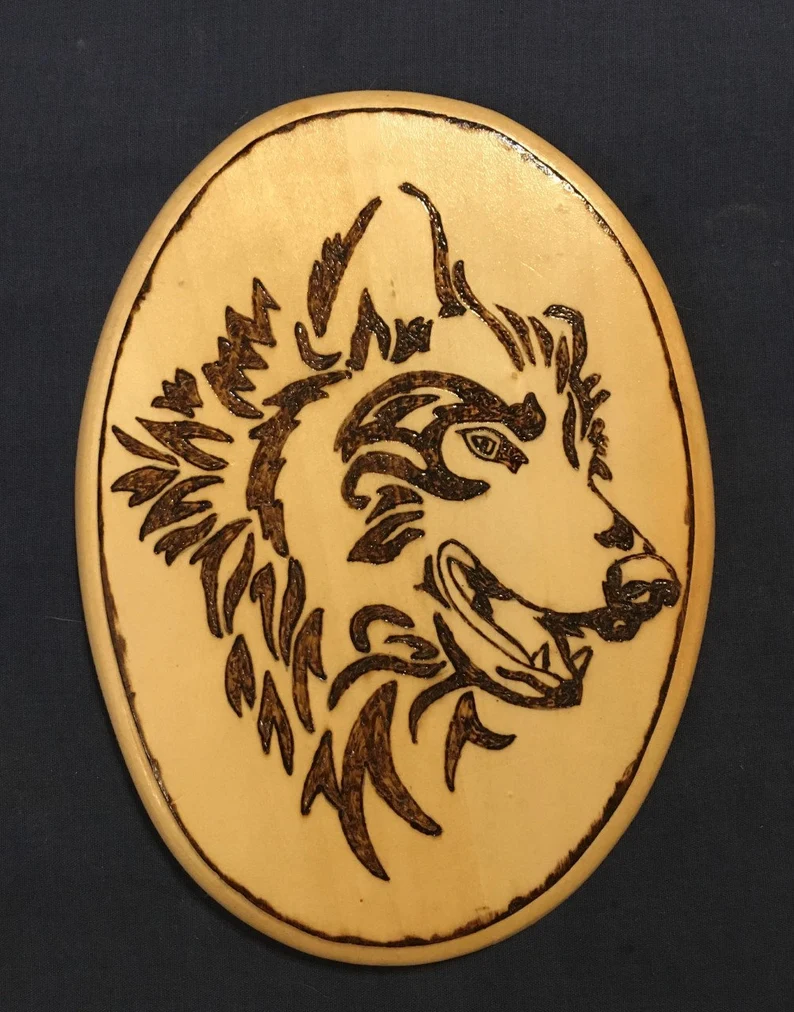 Wooden plaque of a wood burned wolf