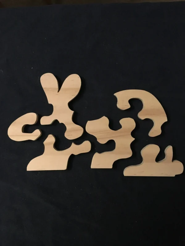 Separated pieces for a wooden puzzle of a bunny