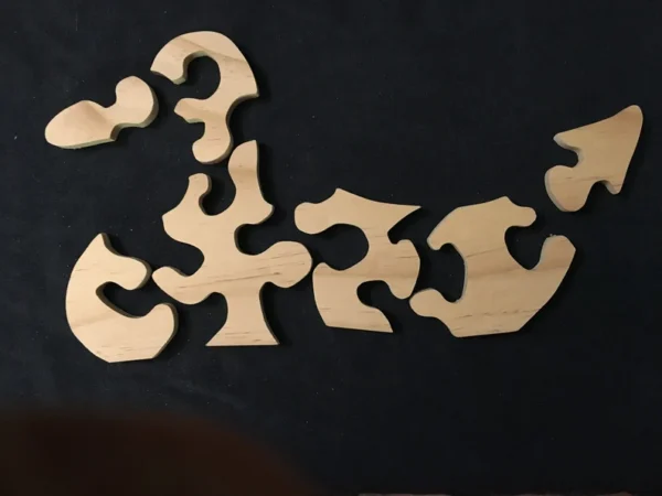 Separated pieces for a wooden puzzle of a duck