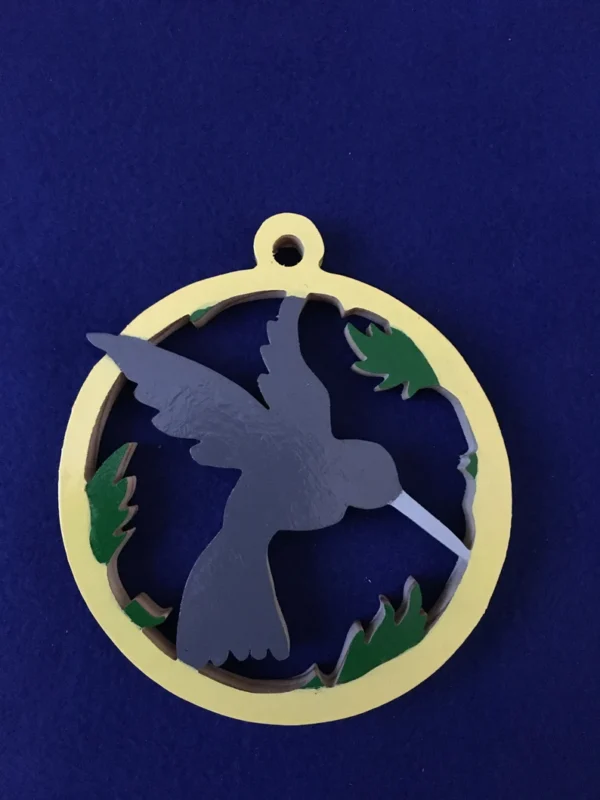 Wooden hummingbird painted blue in a white ring