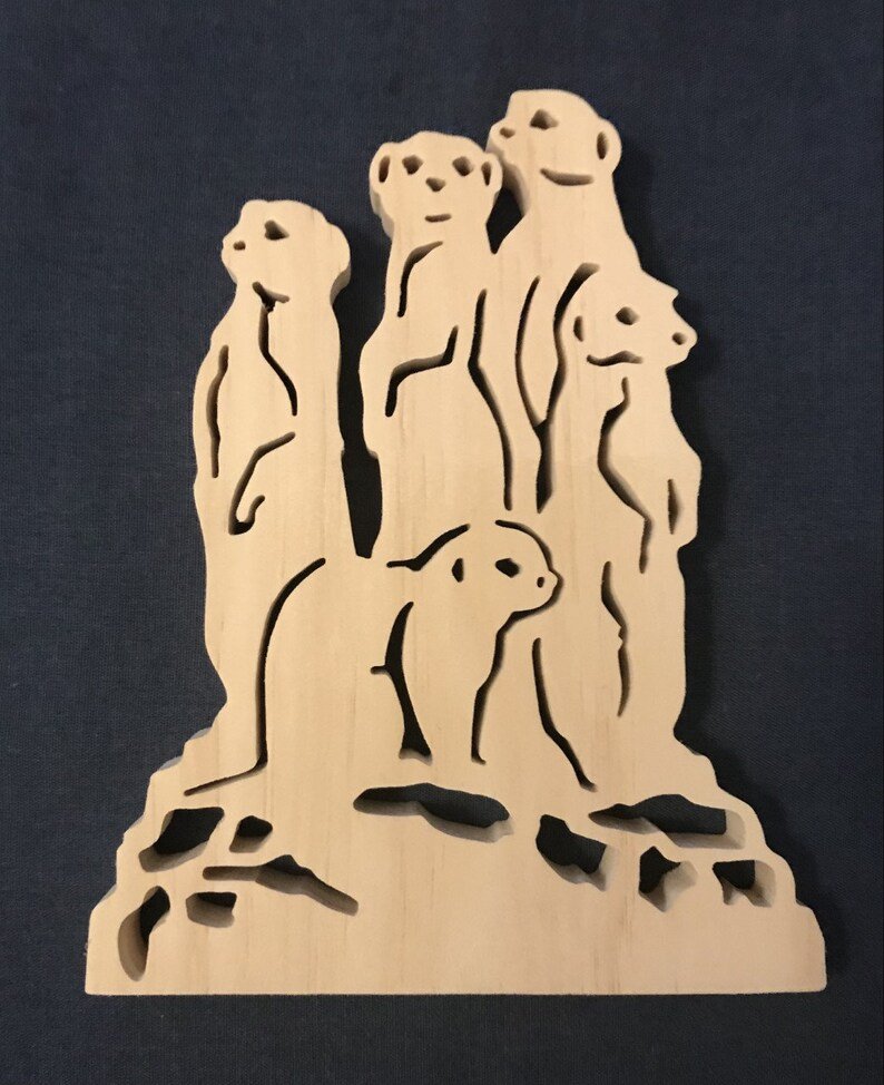 Wooden decoration of meerkats