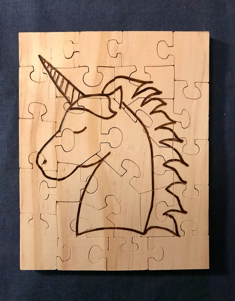 Wooden puzzle with a unicorn wood burned onto it