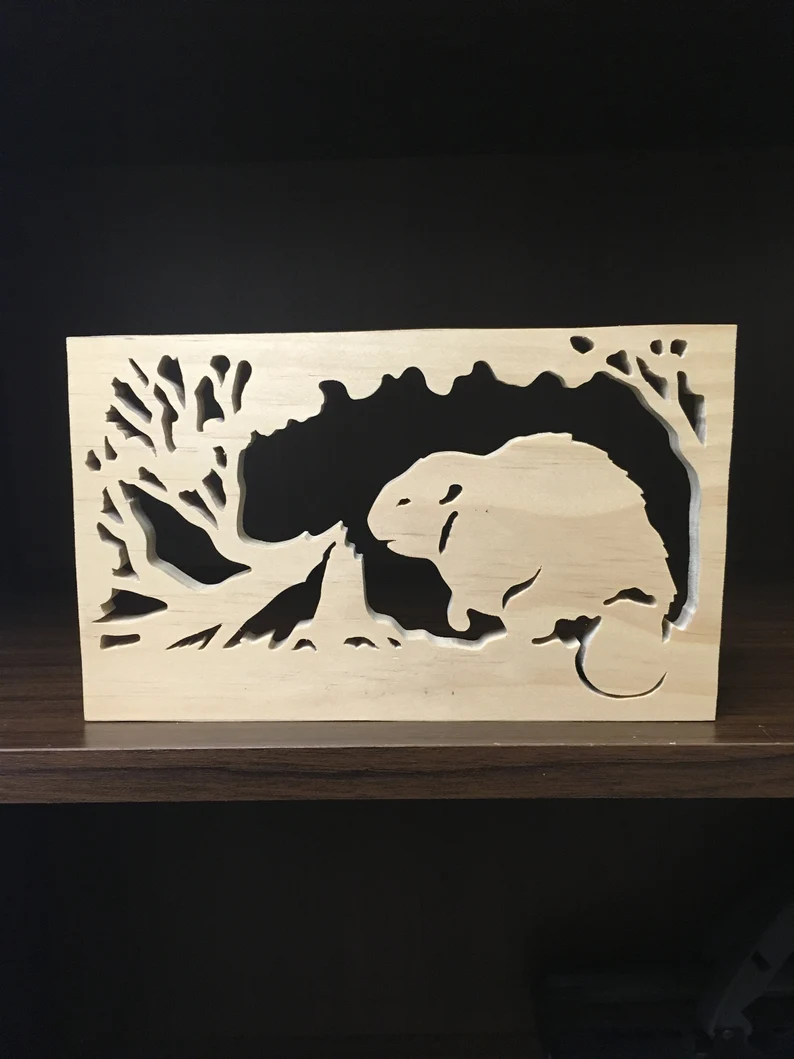 wooden beaver that chopped down a tree, made with a scroll saw