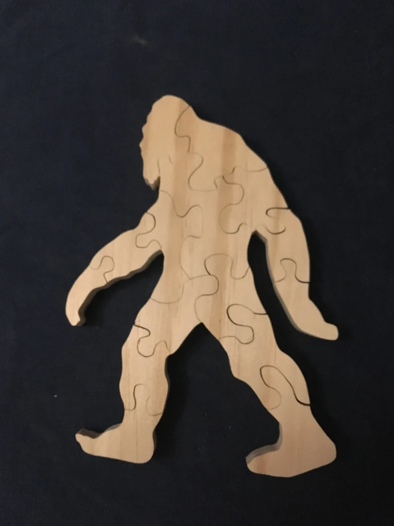 wooden bigfoot cut into puzzle pieces