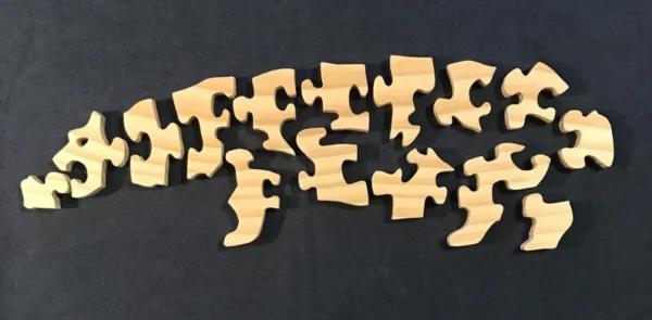 separated pieces of a wooden hippo puzzle