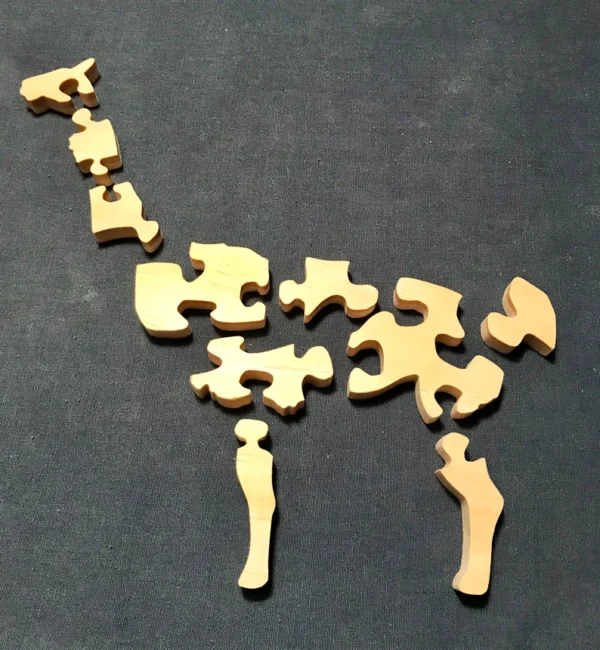 separated pieces of a wooden llama puzzle