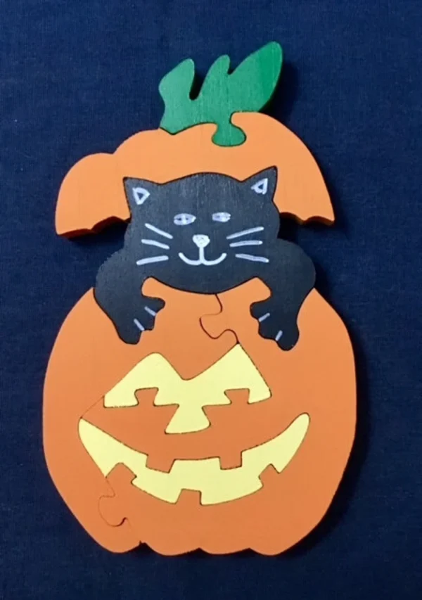 painted wooden pumpkin with a kat playing peek-a-boo in it