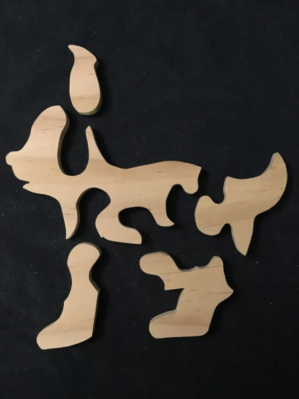 separated pieces of a wooden puppy puzzle set