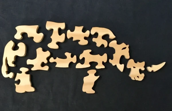 separated pieces of a wooden rhino puzzle